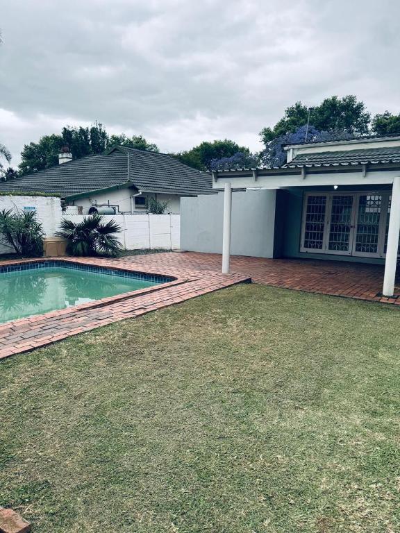 a house with a swimming pool in the yard at Eagles Enest BnB in Pietermaritzburg