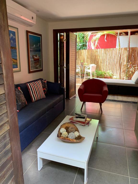 a living room with a couch and a table at Itacimirim Beach House in Camacari