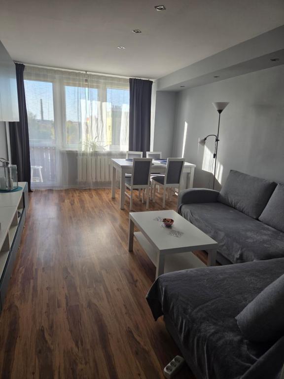 a living room with a couch and a table at Apartament KARO in Zawiercie
