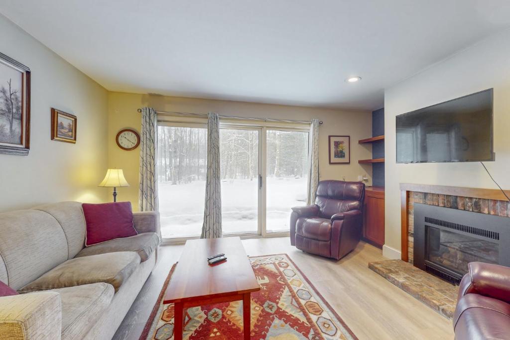 un salon avec un canapé et une cheminée dans l'établissement Mountain Breeze, à Warren