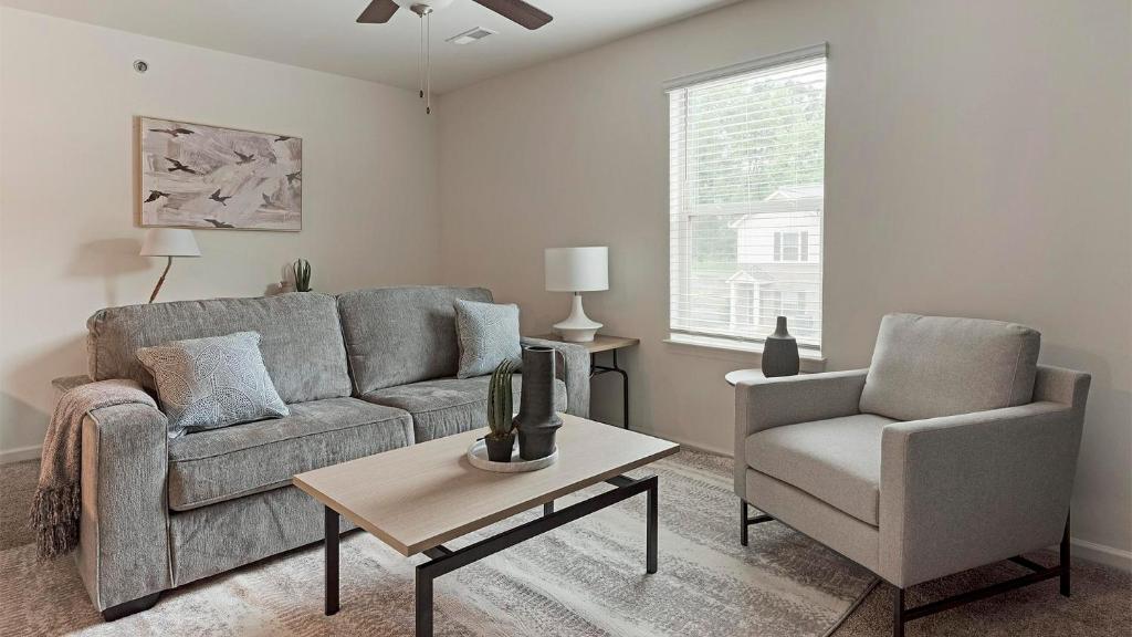 a living room with a couch and a chair and a table at Landing at Cove at Pine Ridge - 1 Bedroom in Lyman in Lyman