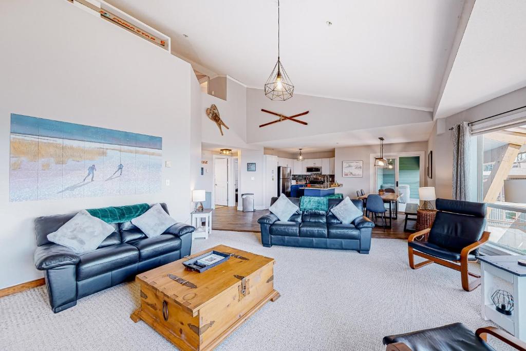 a living room with two couches and a coffee table at Hilltop Hideaway - Legacy 401AB in Big White