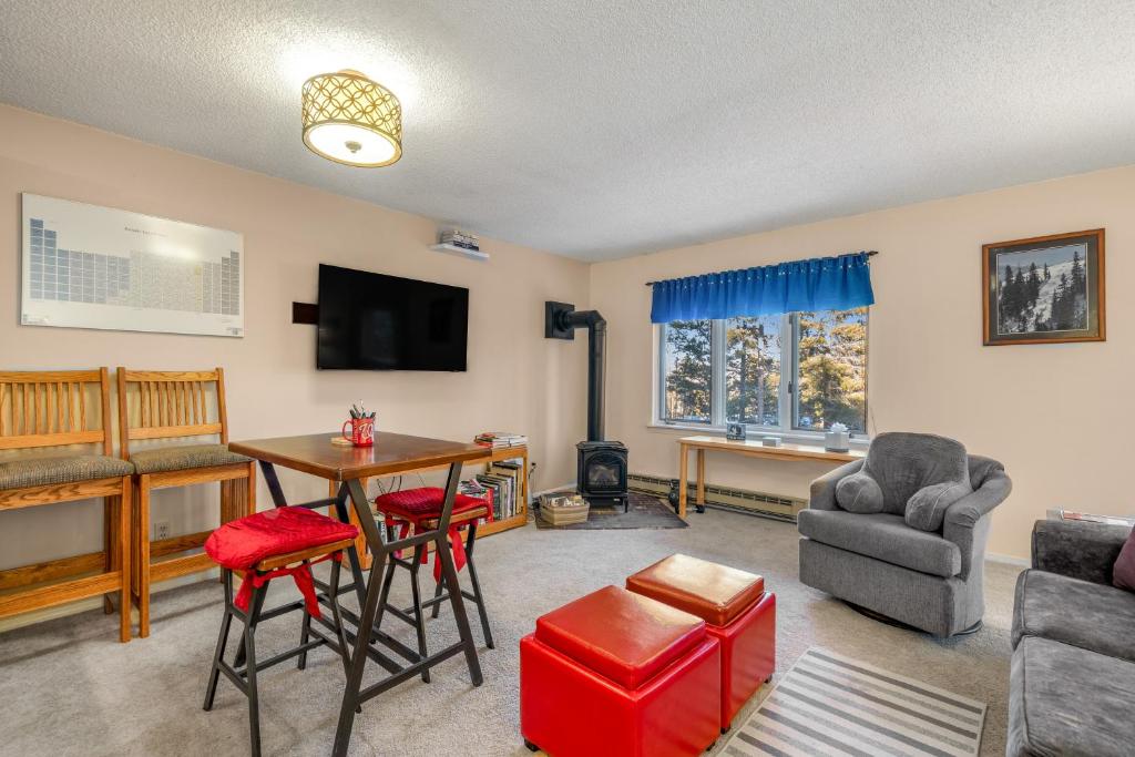 a living room with a table and chairs and a television at Grandview Condo in Breckenridge