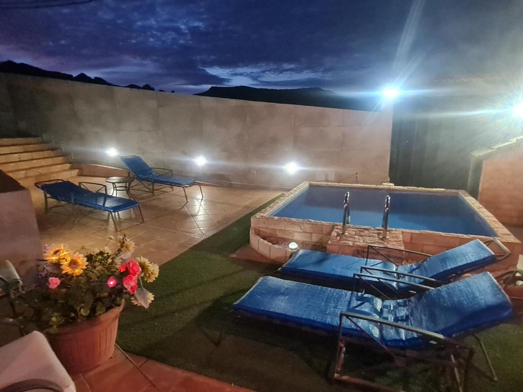 an outdoor swimming pool with a table and chairs at Casa La Gollada in Cazadores