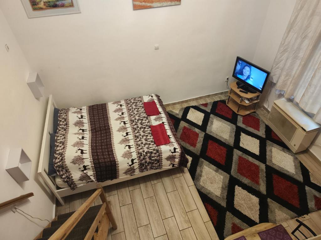 an overhead view of a living room with a bed and a television at Erik Apartments in Budapest