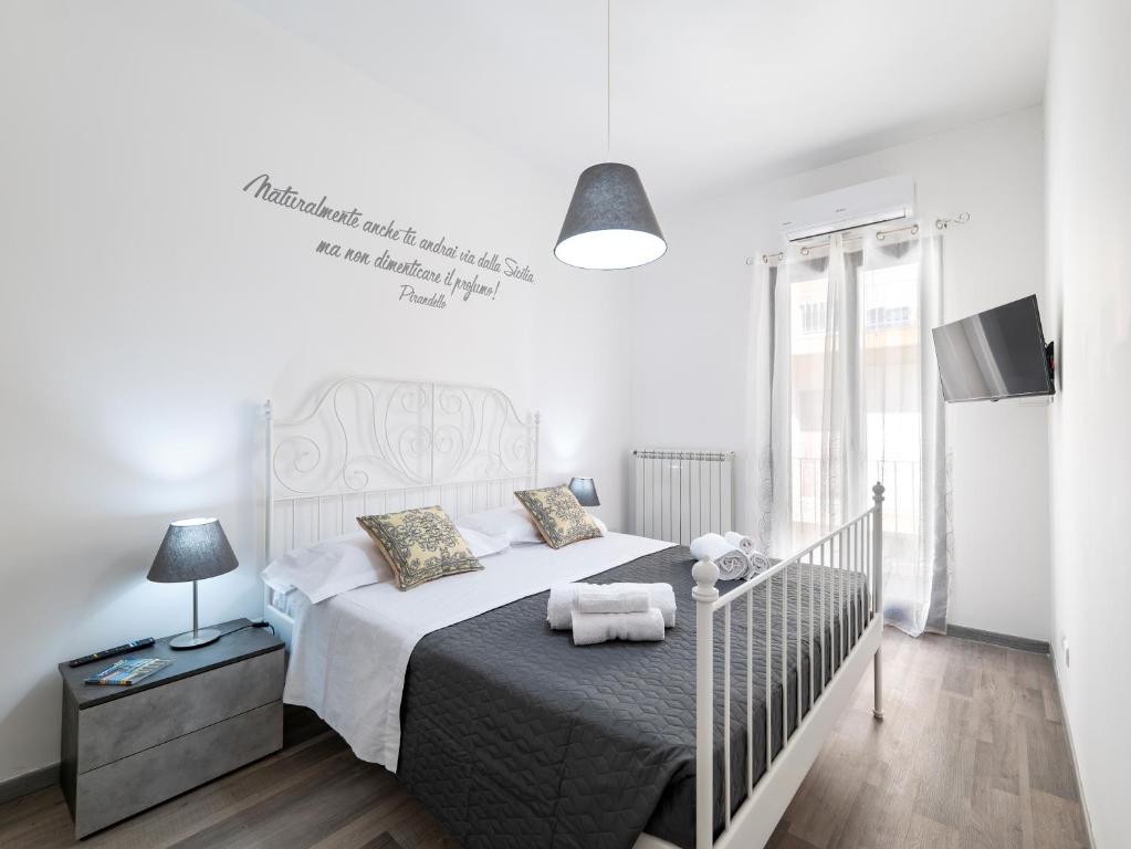 a bedroom with a large bed with a white bedspread at Le due Sicilie -Ragusa Guest House in Ragusa