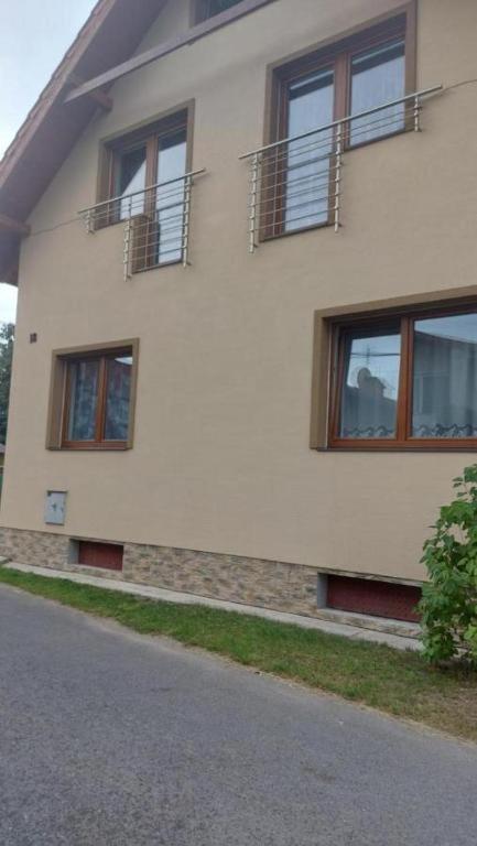 a white building with windows on the side of it at Ubytovanie michaela in Bešeňová
