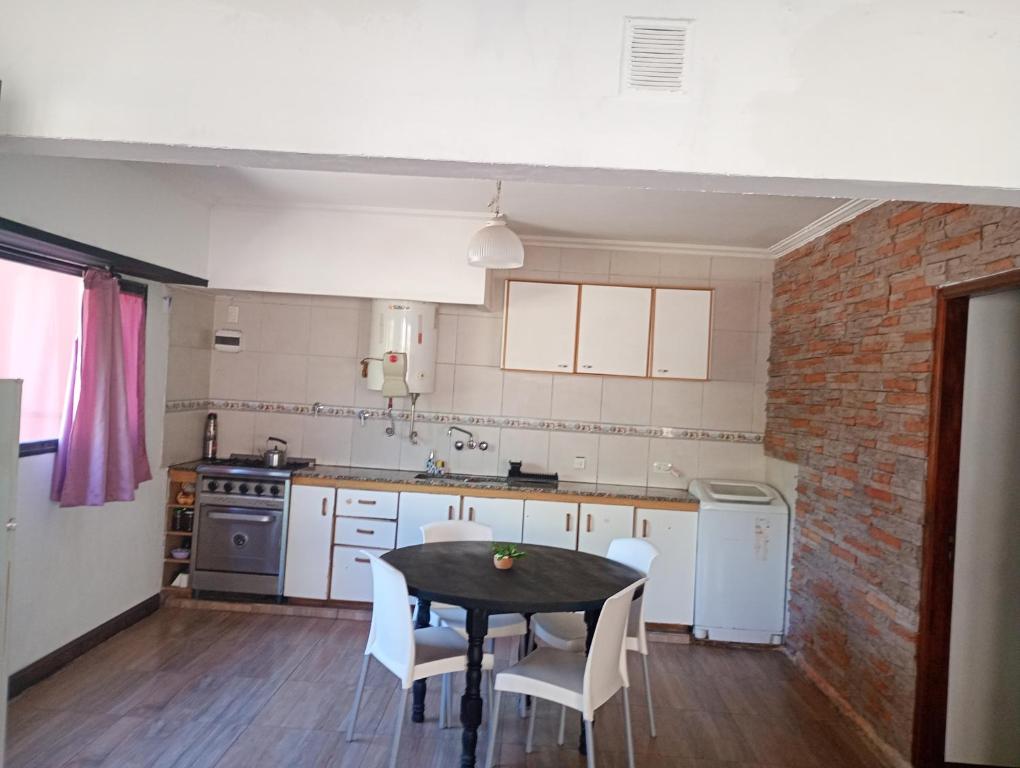 a kitchen with a table and chairs in a room at Lo de Charo in Miramar