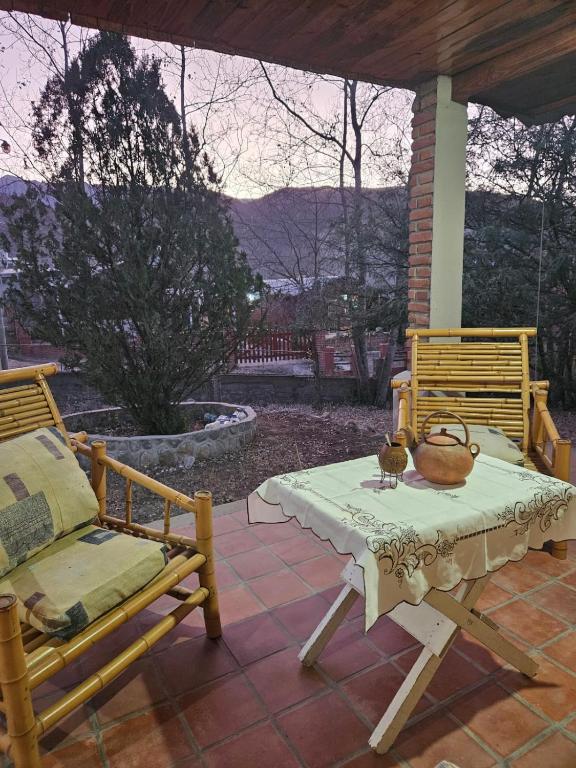 a table and two chairs on a patio at Pacha Quilla in El Mollar