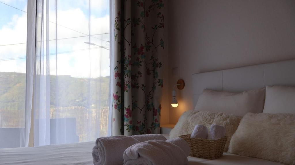 a bedroom with a bed and a large window at Estadia dos Sonhos in Sequeiros