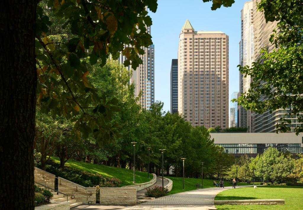 a park in the middle of a city with tall buildings at Fairmont Chicago Millennium Park in Chicago