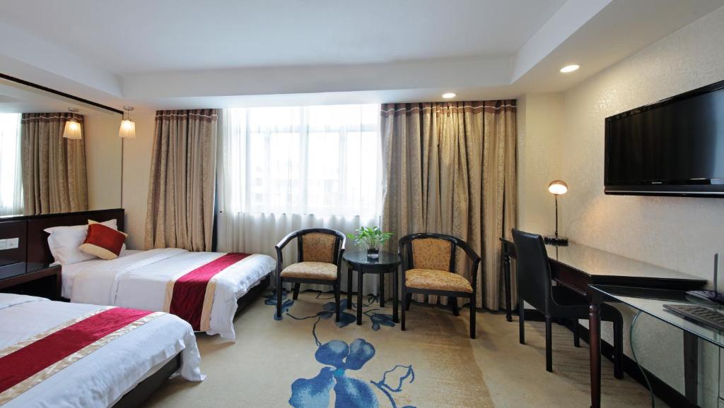 Postel nebo postele na pokoji v ubytování New World Hotel