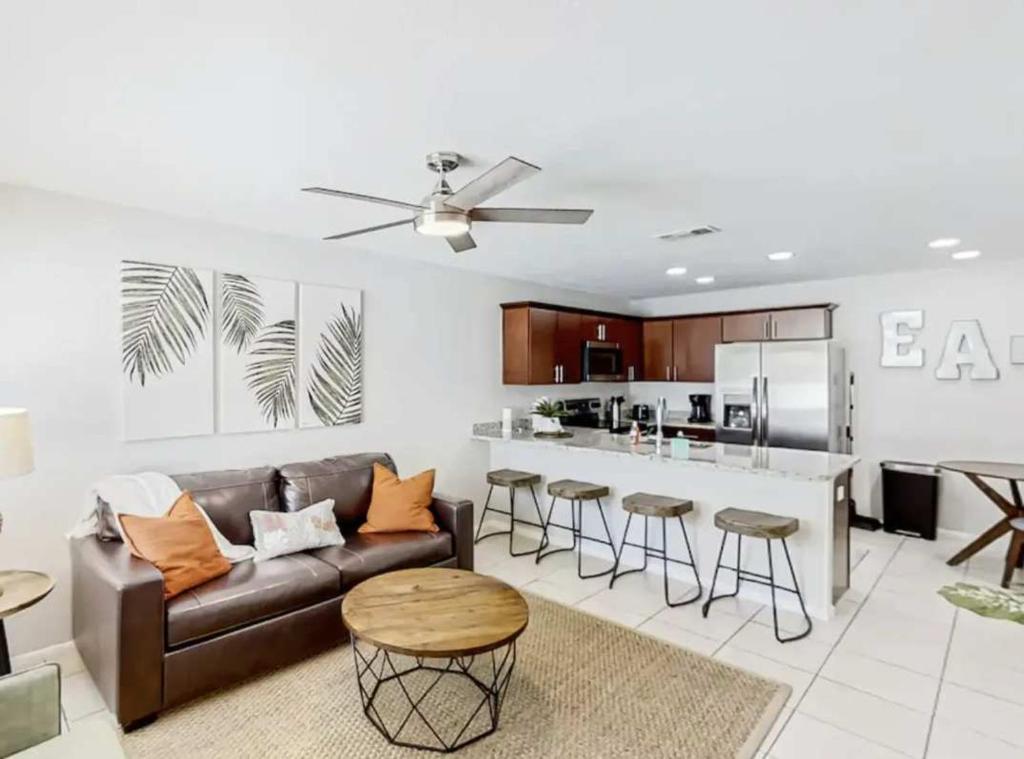 a living room with a couch and a kitchen at Family & Pet Friendly-Waterfront-Sleeps 4 in Apollo Beach