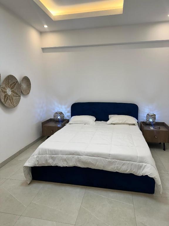 a bedroom with a large bed with two night stands at Studio meublé premium in Dakar