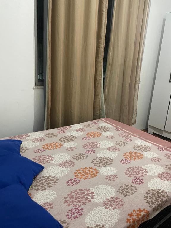a bedroom with a bed with a quilt on it at Condomínio Dom Francisco in Belém