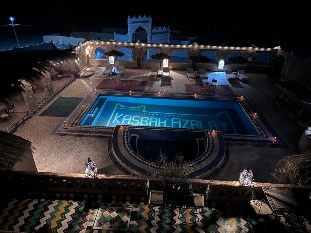 an overhead view of a swimming pool at night at Kasbah Azalay Merzouga takojt in Merzouga