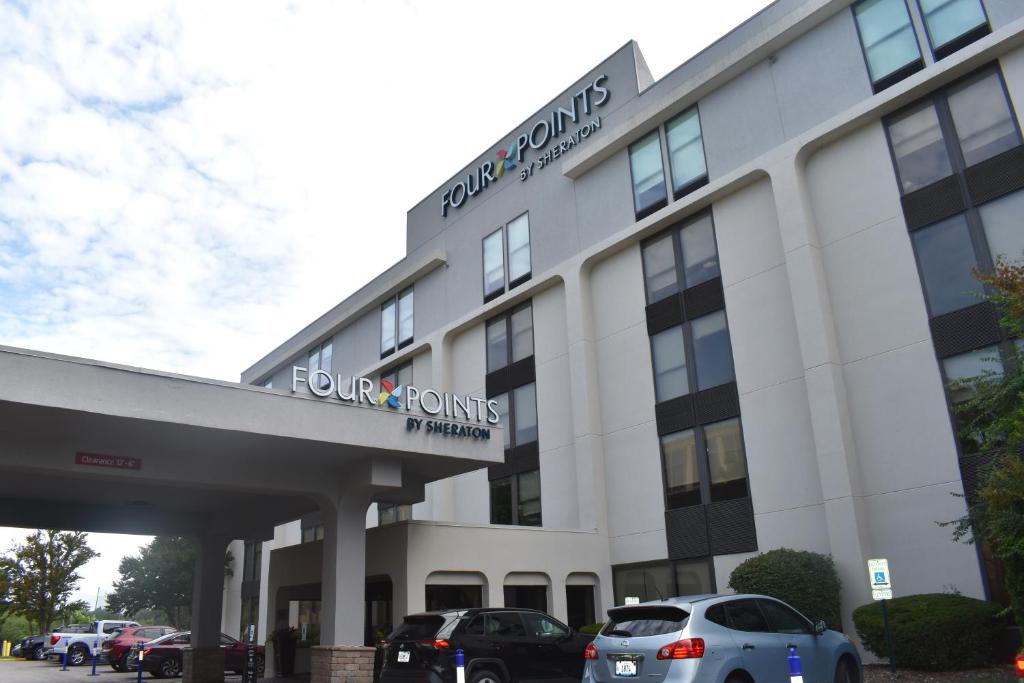 a building with cars parked in front of it at Four Points by Sheraton Chicago Westchester/Oak Brook in Westchester