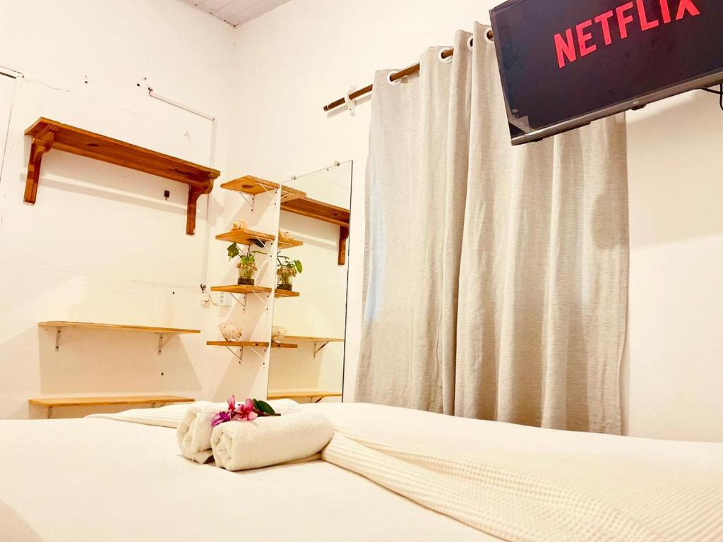 a bedroom with a bed with a netflix sign on it at Casa Baly Jericoacoara in Jericoacoara