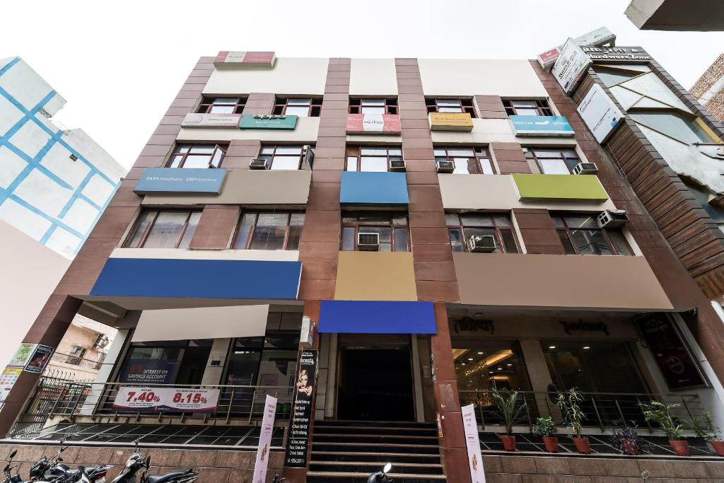 a tall building with stairs in front of it at Hotel O Landlord in Rohtak