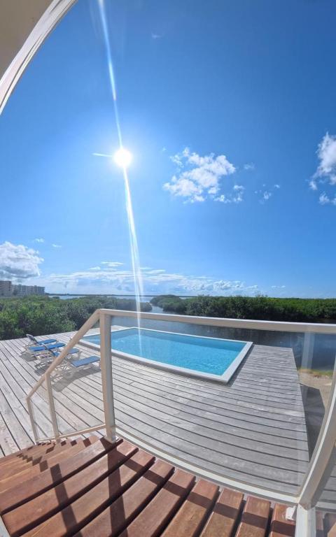 a view from the deck of a house with a swimming pool at Bella Vista Resort Belize in San Pedro