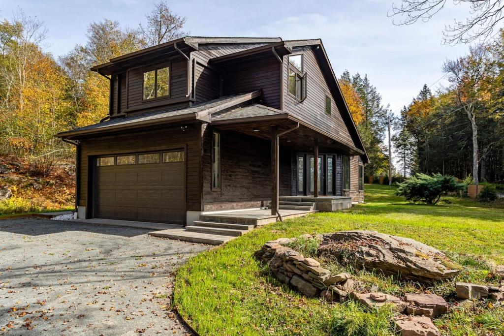 a brown house with a garage in a yard at Dreamwood in Jeffersonville