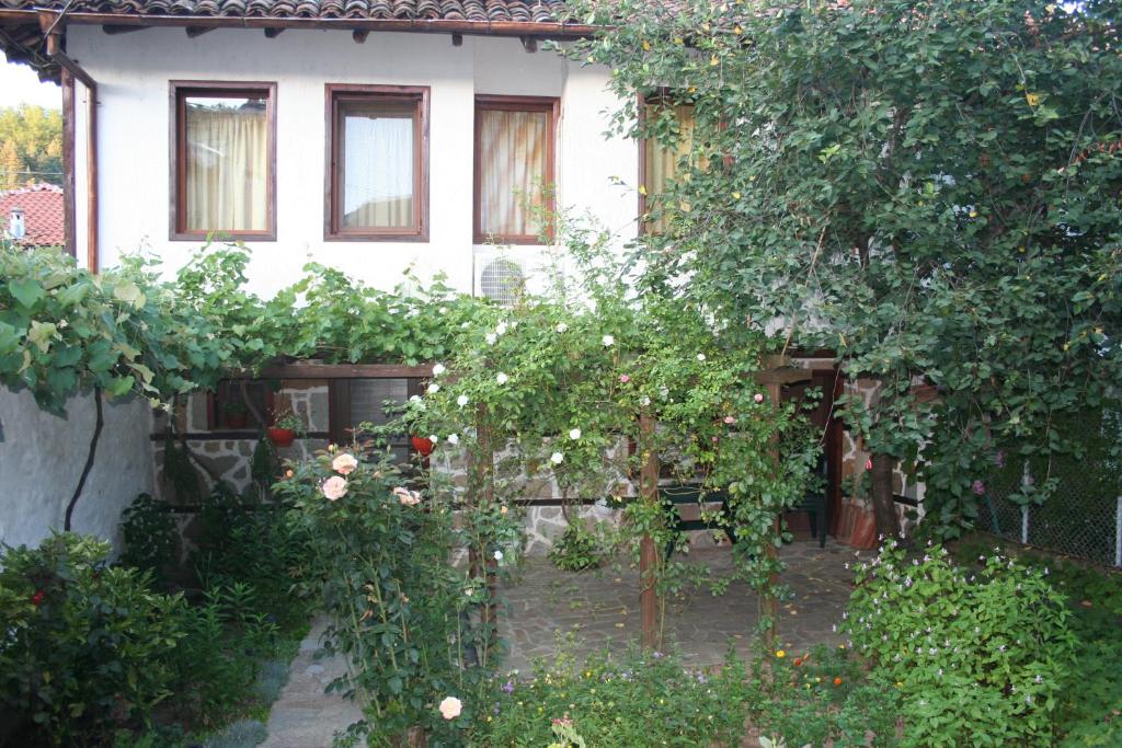 a house with a bunch of trees in front of it at Todorova House in Zlatograd