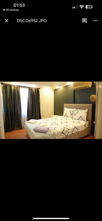 a bedroom with a bed with white sheets and pillows at Artan rezidans 519 in Konak