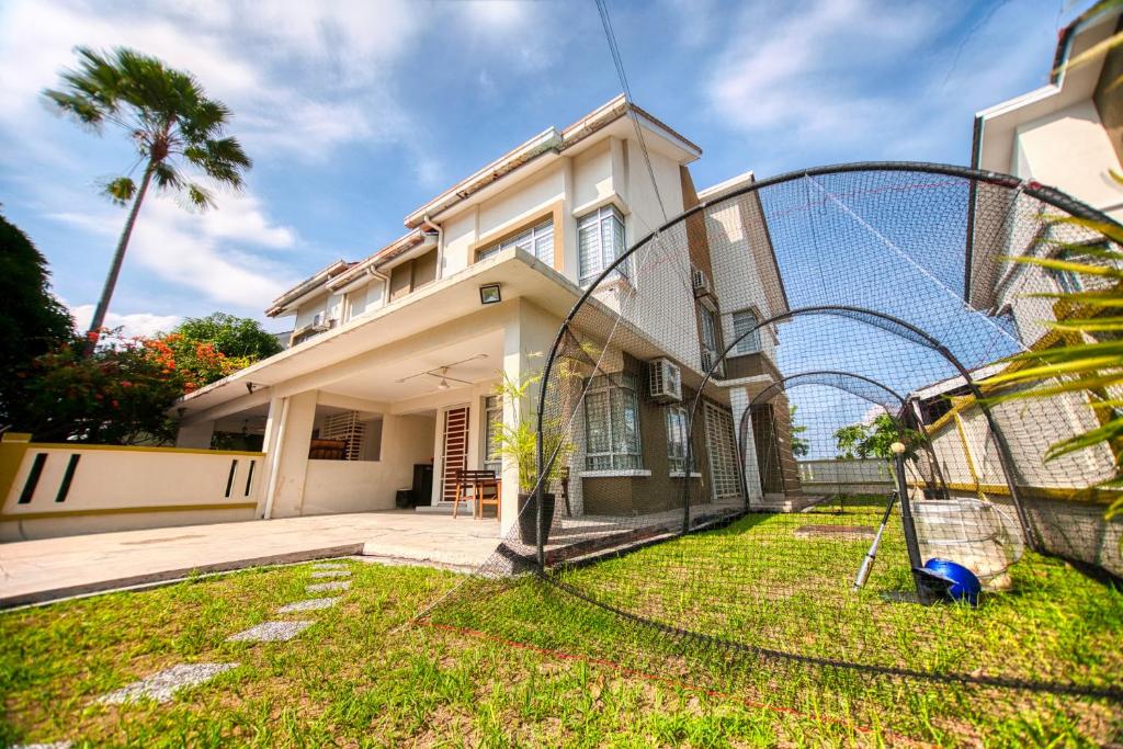 a house with a basketball hoop in the yard at D'PrinceDream in Port Dickson