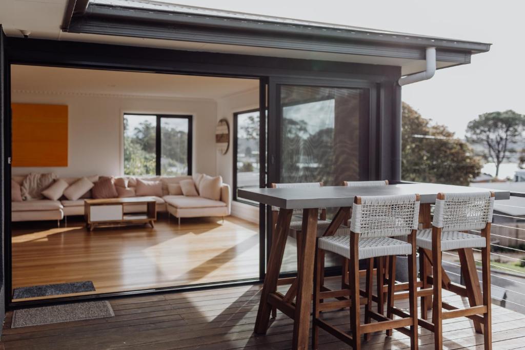 a kitchen and living room with a table and chairs at Doric Dreams - Short Stroll to St Helens in St Helens