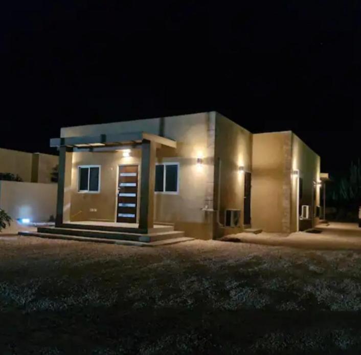 una pequeña casa por la noche con las luces encendidas en N-Joy Aruba, en Cunucu Abao