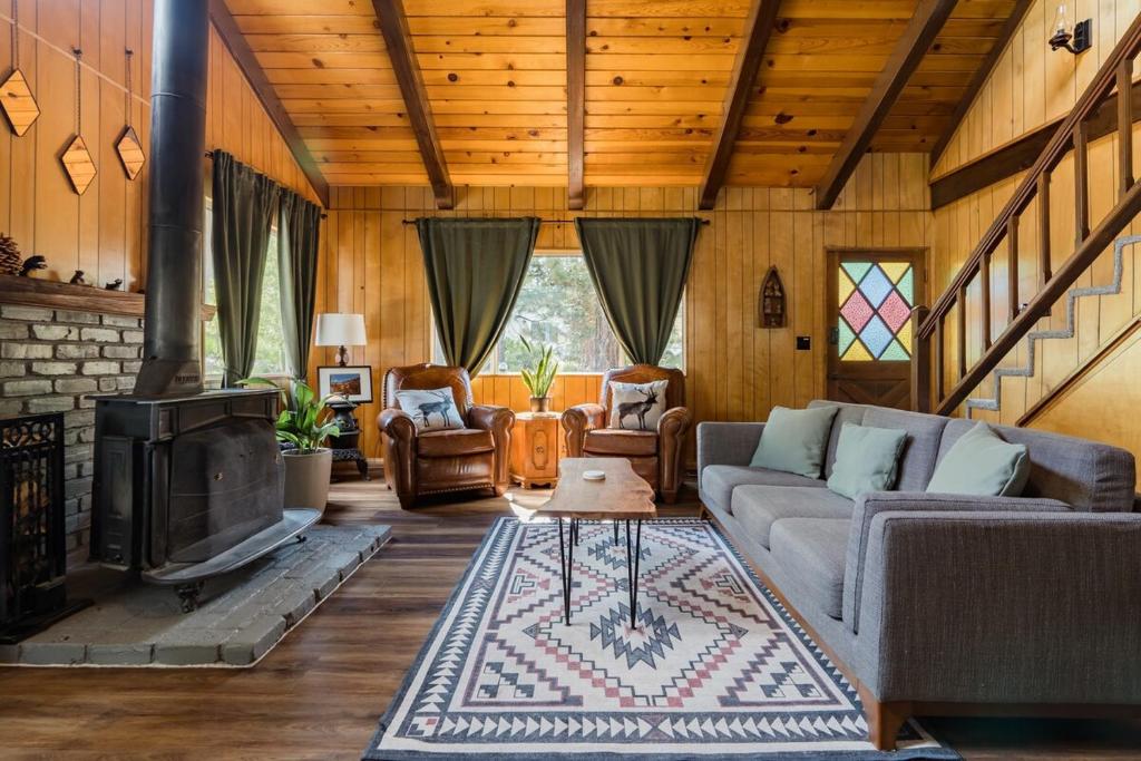 a living room with a couch and a fireplace at Hidden Pines Cabin - Nearby Snow & Play in Big Bear City Airport