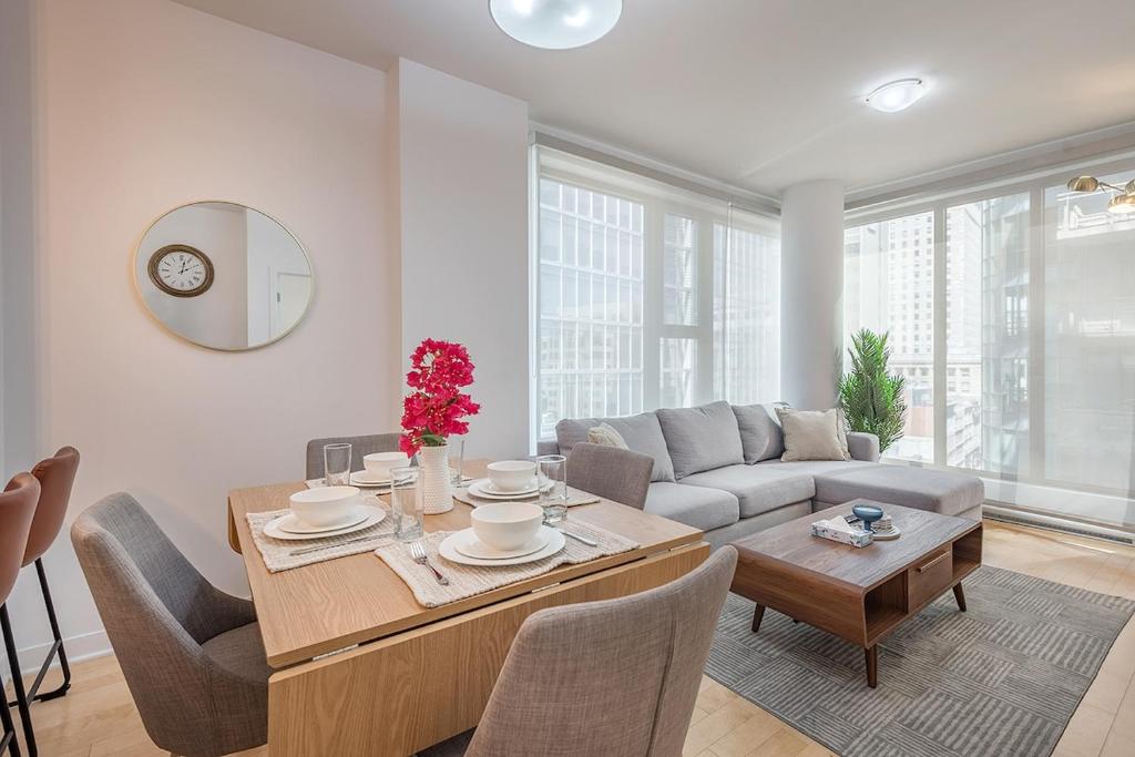 a living room with a table and a couch at Corner 2BR Old Port - Free Indoor Parking in Montreal