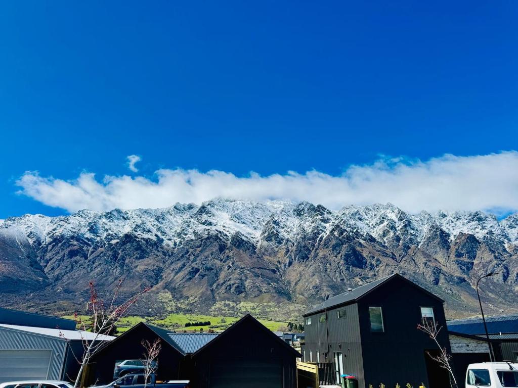 a mountain range with snow covered mountains in the background at Hiking Golf Skiing Lake Remarkables 7 Min Airport in Queenstown