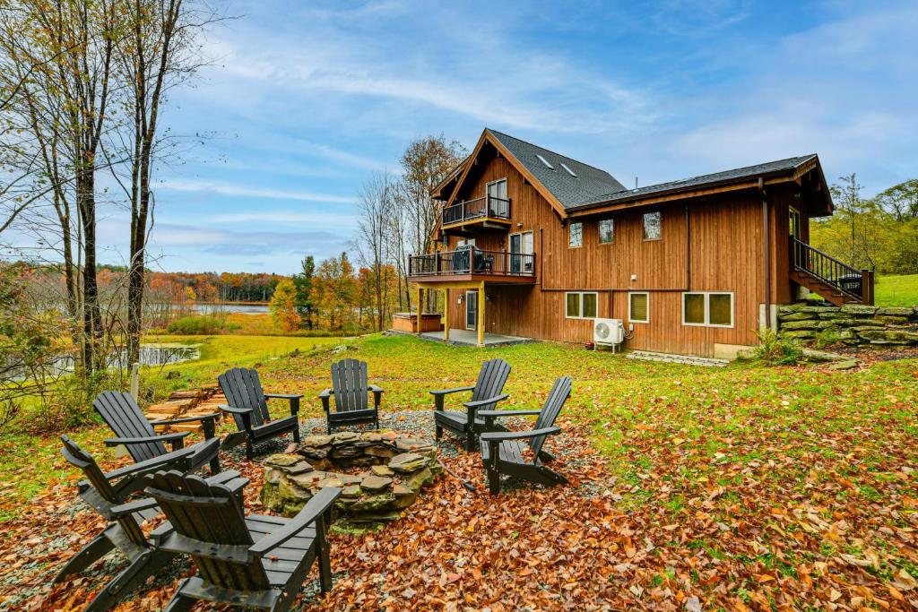 a group of chairs sitting in front of a house at Golf, Fish and Ski Retreat with Game Room in Thompson in Thompson
