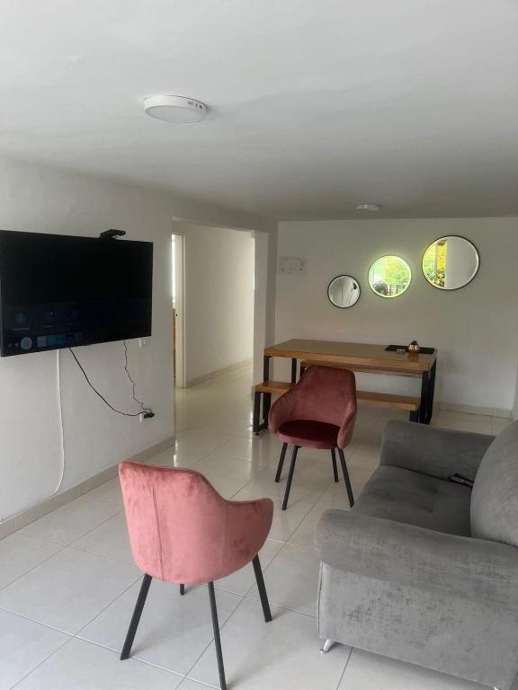 a living room with a couch and a table at Full apartment near El Poblado in Medellín