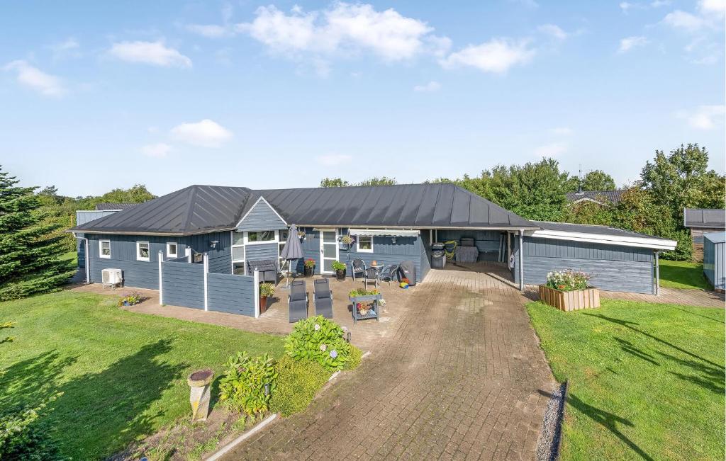 an aerial view of a blue house with a yard at Stunning Home In Tarm With Sauna in Højsand