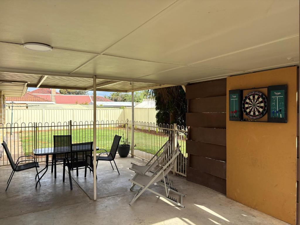 a patio with a table and chairs and a window at The Townhouse in Renmark
