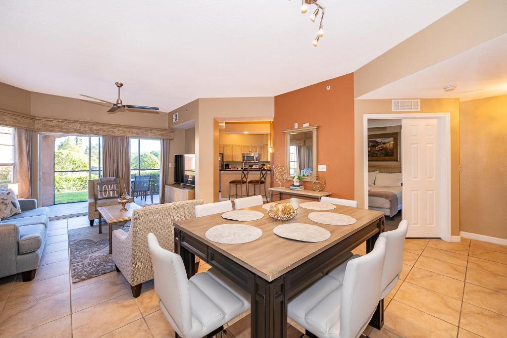 a dining room and living room with a table and chairs at Pura Vida in Orlando