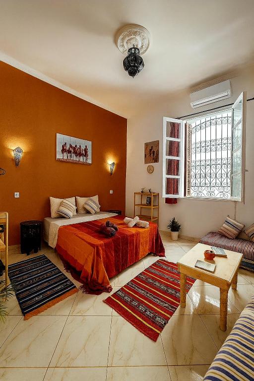a bedroom with a bed and a living room at Kasbah Nights Retreat and best breakfast offers - Entire House in Tangier
