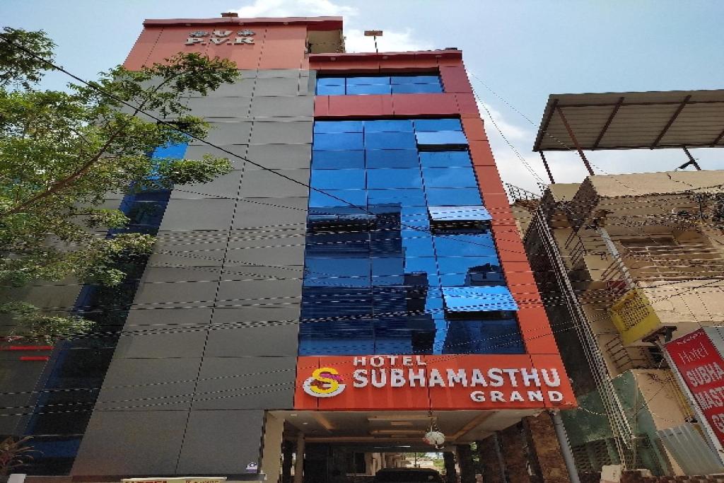 a tall building with a sign in front of it at Collection O Sri Subhamastu Grand in Vijayawada