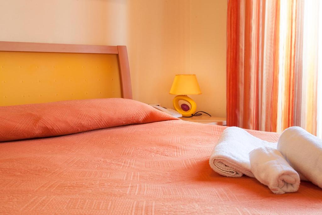 Posteľ alebo postele v izbe v ubytovaní Blu Hotel