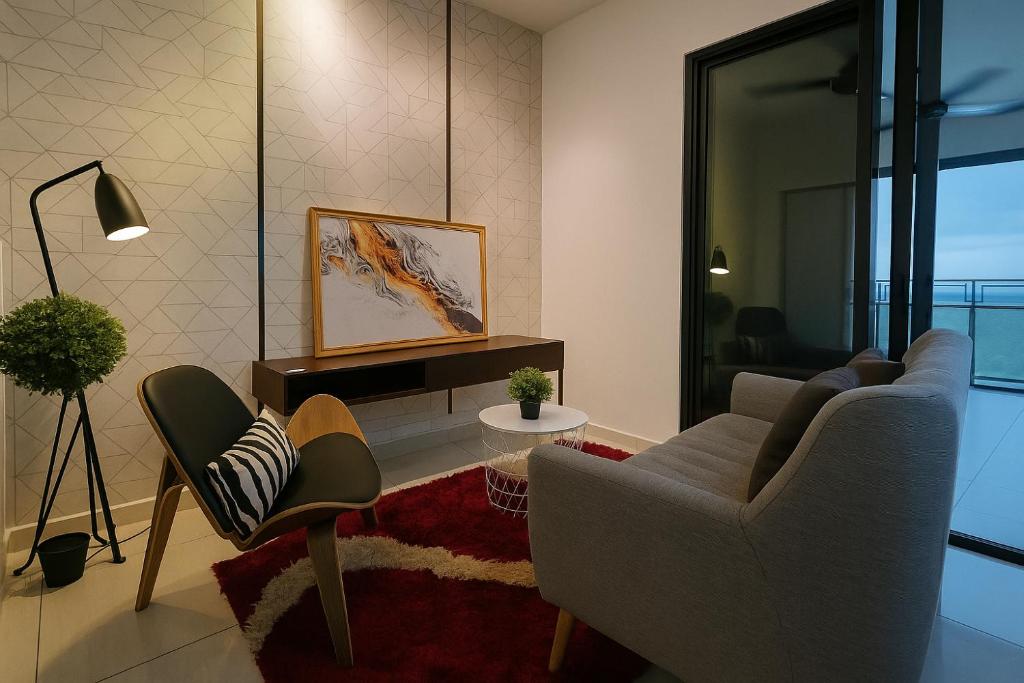 a living room with a couch and a chair at Alma's Suites Luna Studio 2Pax Puteri Harbour by Our Stay in Iskandar Puteri