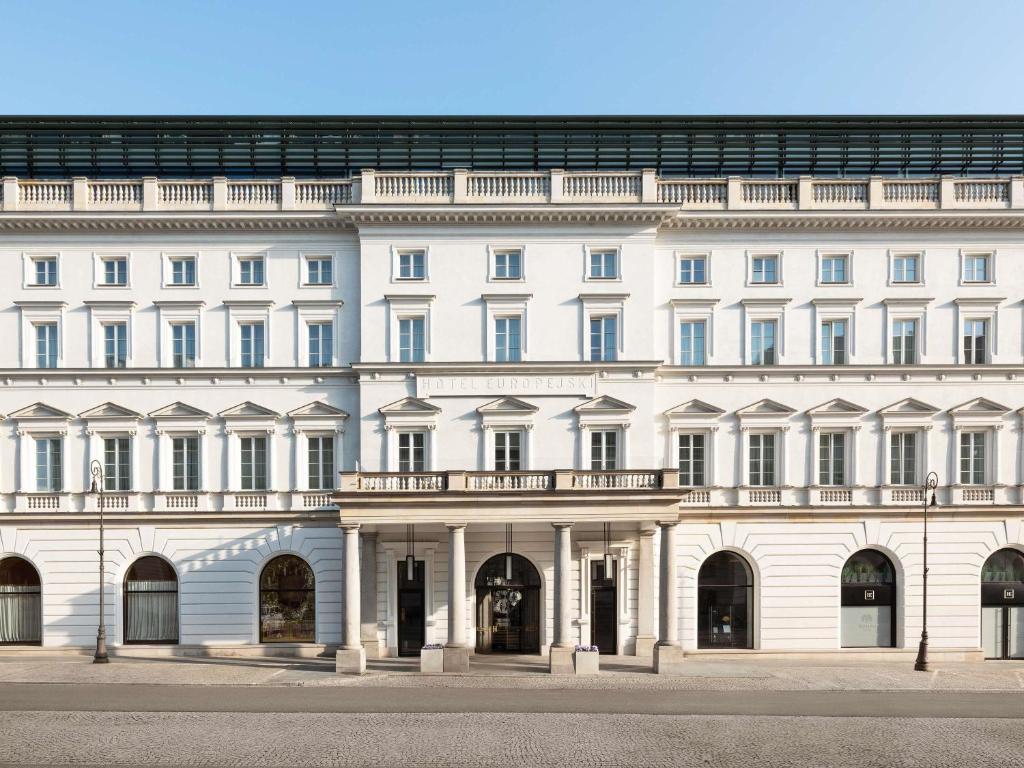 a large white building with a balcony at Raffles Europejski Warsaw in Warsaw