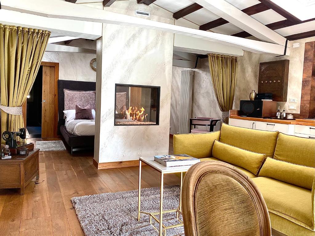 a living room with a couch and a fireplace at MURANO Suites BOUTIQUE Apartments adults only in Murano