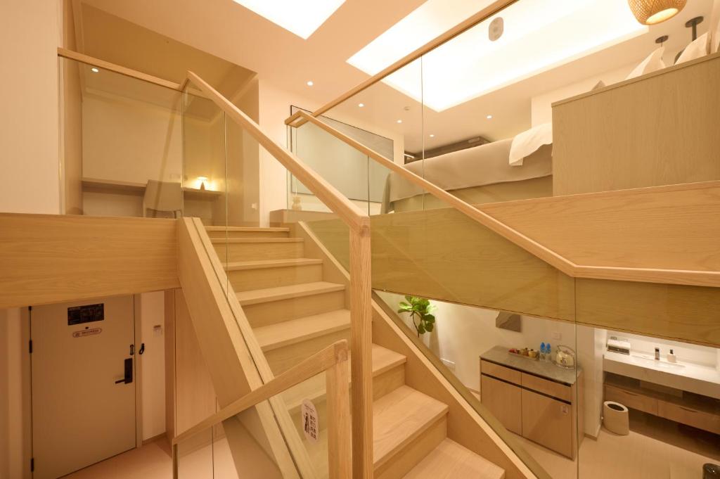 a staircase leading up to a loft apartment at Qinghai Xisu in Dalian