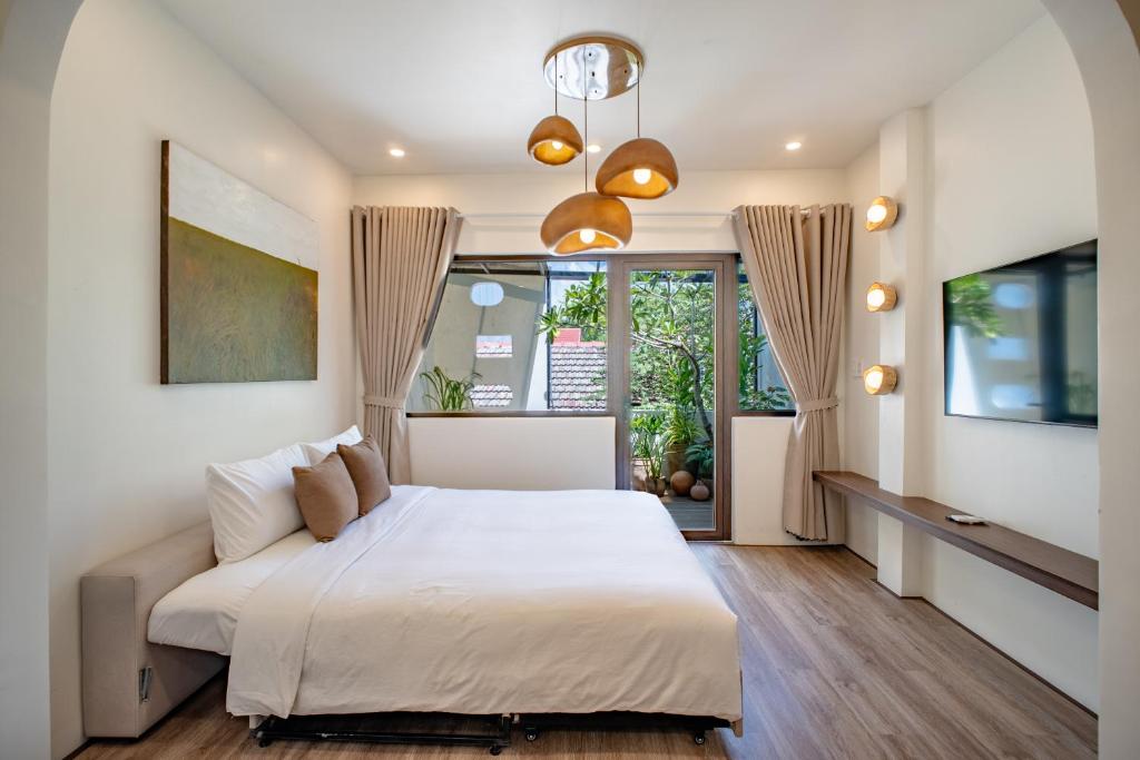 Giường trong phòng chung tại Casa De Lua Hoi An