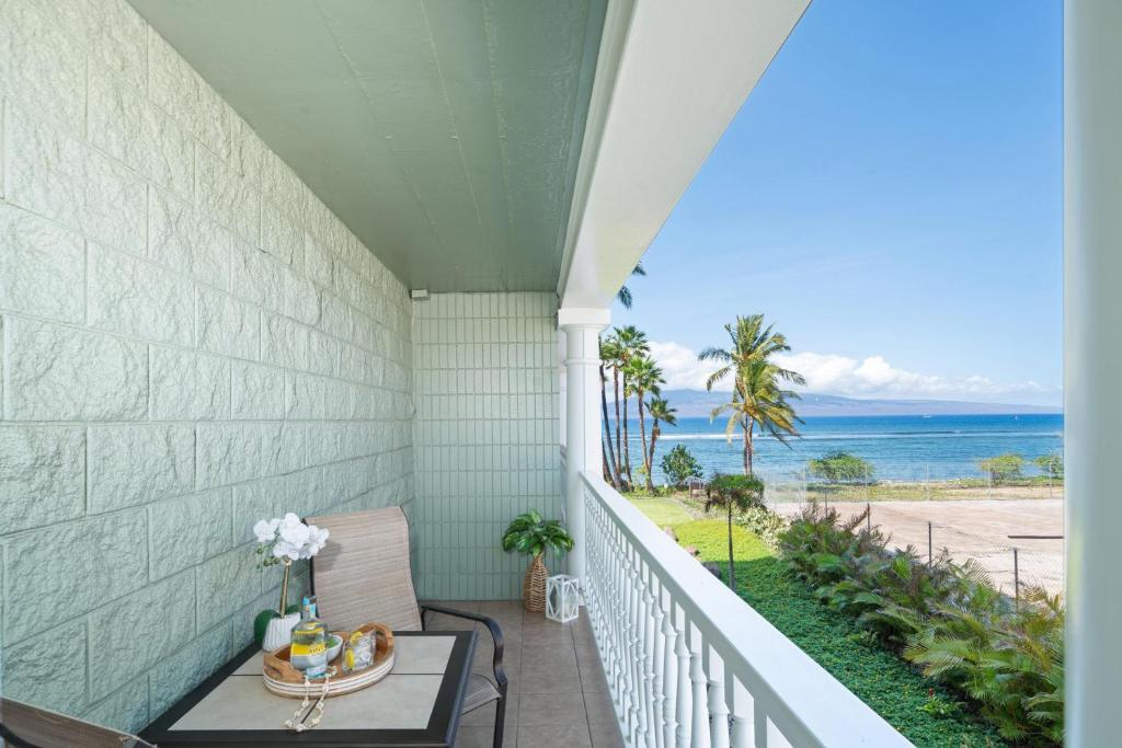 a porch with a table and a view of the ocean at Lahaina Shores 234 in Wainee