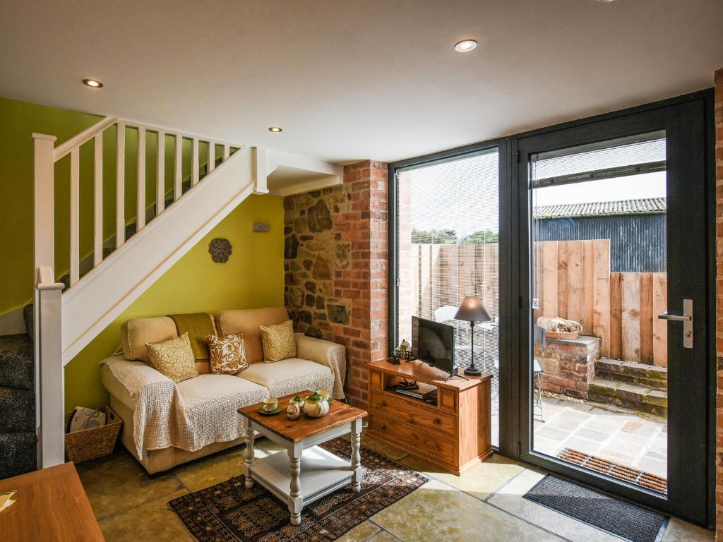 a living room with a couch and a tv at Shropshire Way Stay in Farden
