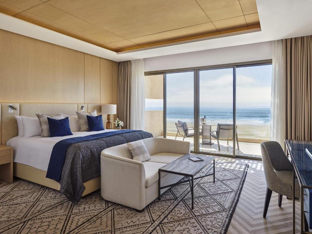 A bed or beds in a room at Fairmont Taghazout Bay