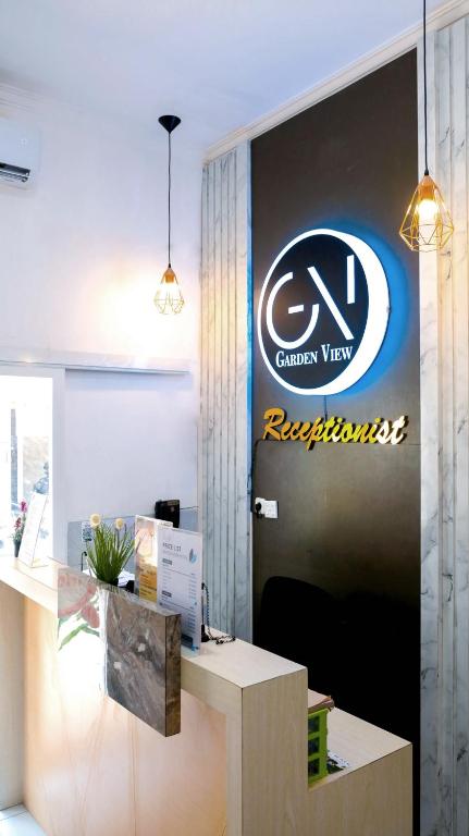 an office with a sign on the wall at Garden View by Calli Rooms in Jember
